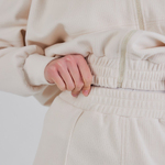 Trouser suit made of high-quality knitwear with an ivory stripe