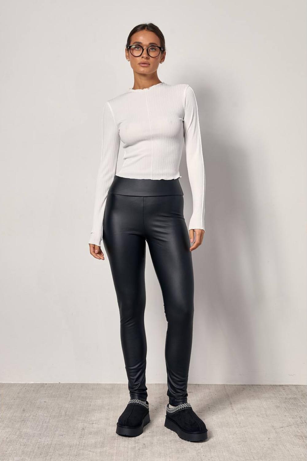 Black leggings made of eco-leather are insulated