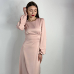 Elegant powder-colored midi-length dress.