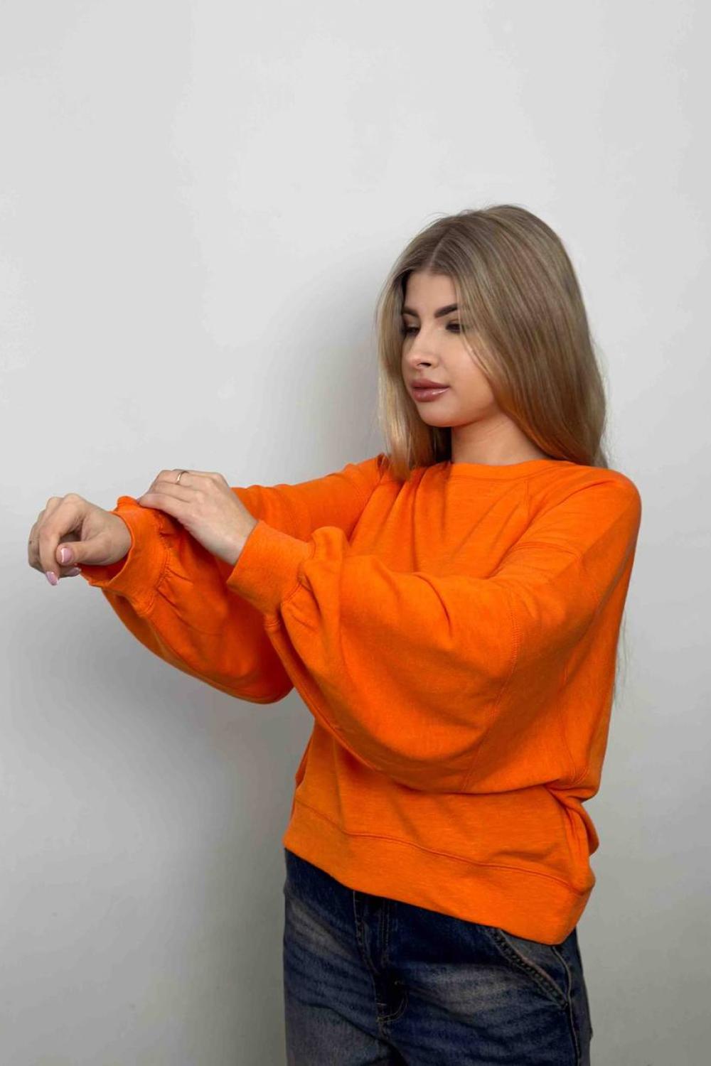 women's sweatshirt is presented in a bright orange color