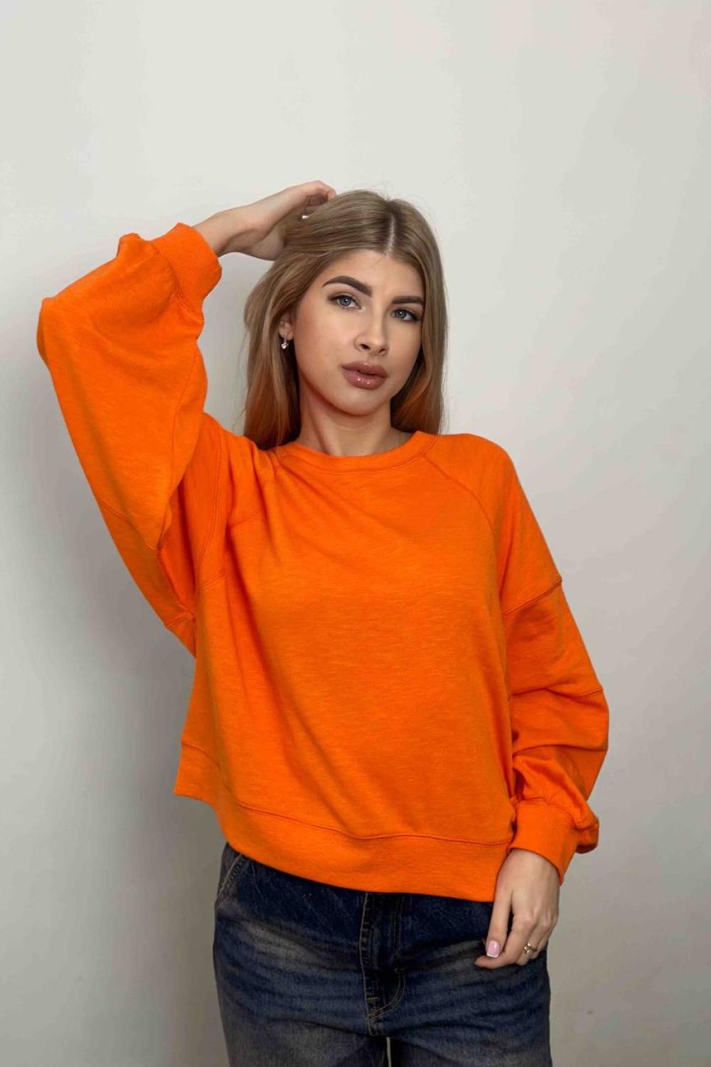 women's sweatshirt is presented in a bright orange color