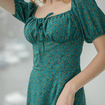 The dress is turquoise in a Hardy floral print
