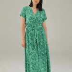 The dress is green with a floral print 15-5098