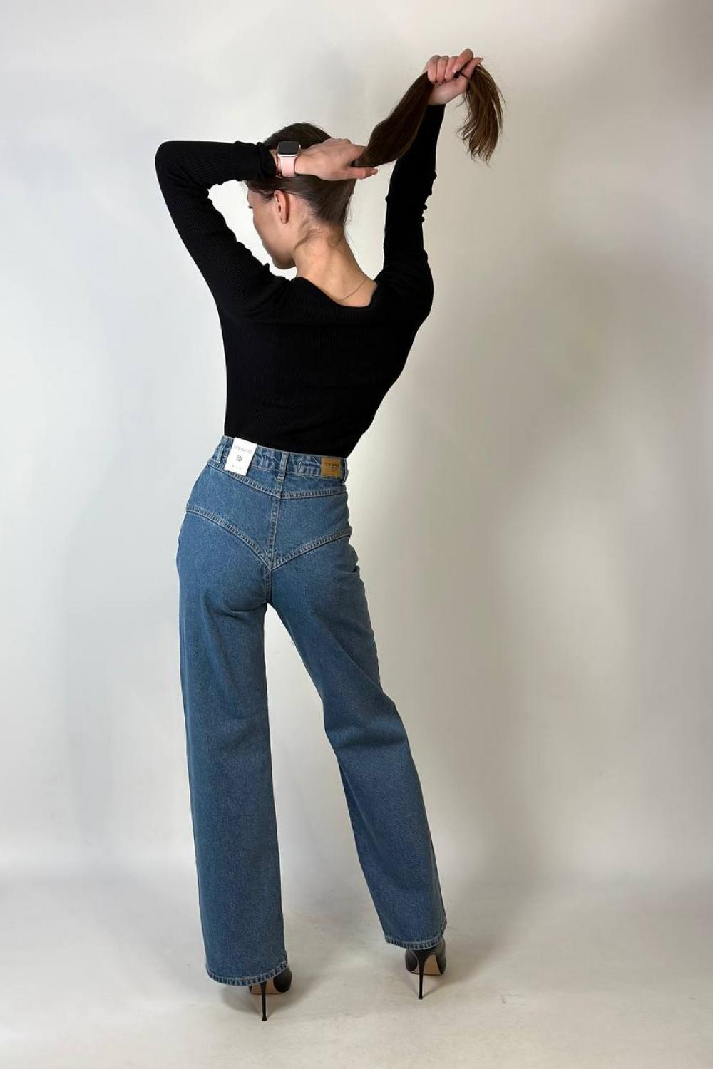 Women's jeans are straight with a curly coquette of blue color