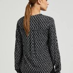 White and black blouse with a geometric pattern