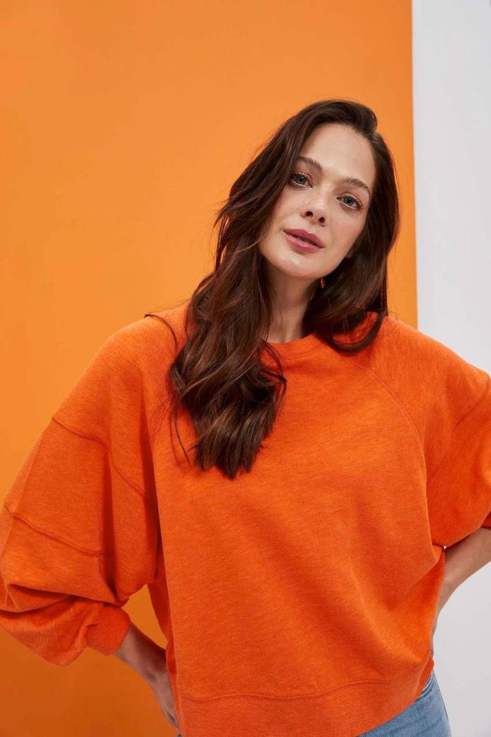 women's sweatshirt is presented in a bright orange color