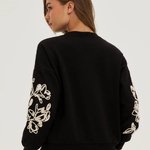 Black sweatshirt with floral appliqué