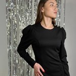 Black knitted dress tailored to the figure. France