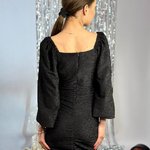 A black cocktail dress made of lurex