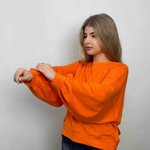women's sweatshirt is presented in a bright orange color