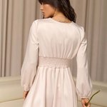 Romantic dress in a soft powdery color with buttons.
