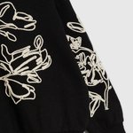 Black sweatshirt with floral appliqué