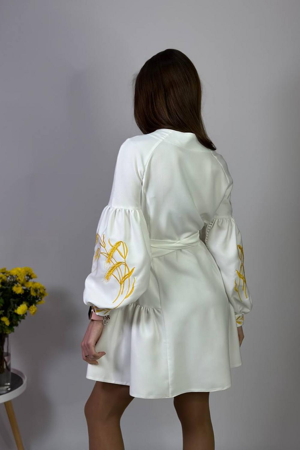 Women's white embroidered dress with gold embroidered spikes