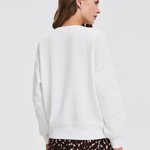White sweatshirt with floral appliqué