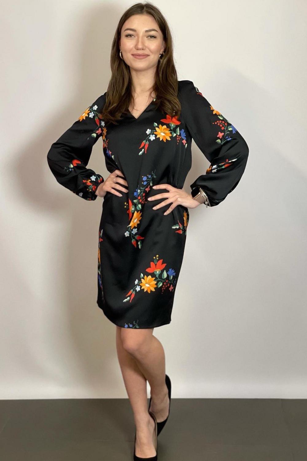 The dress is black with a colorful NocheMio print