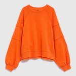 women's sweatshirt is presented in a bright orange color