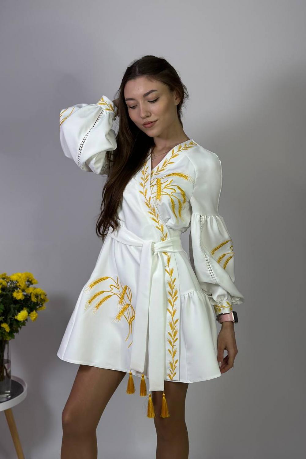 Women's white embroidered dress with gold embroidered spikes