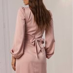 Elegant powder-colored midi-length dress.