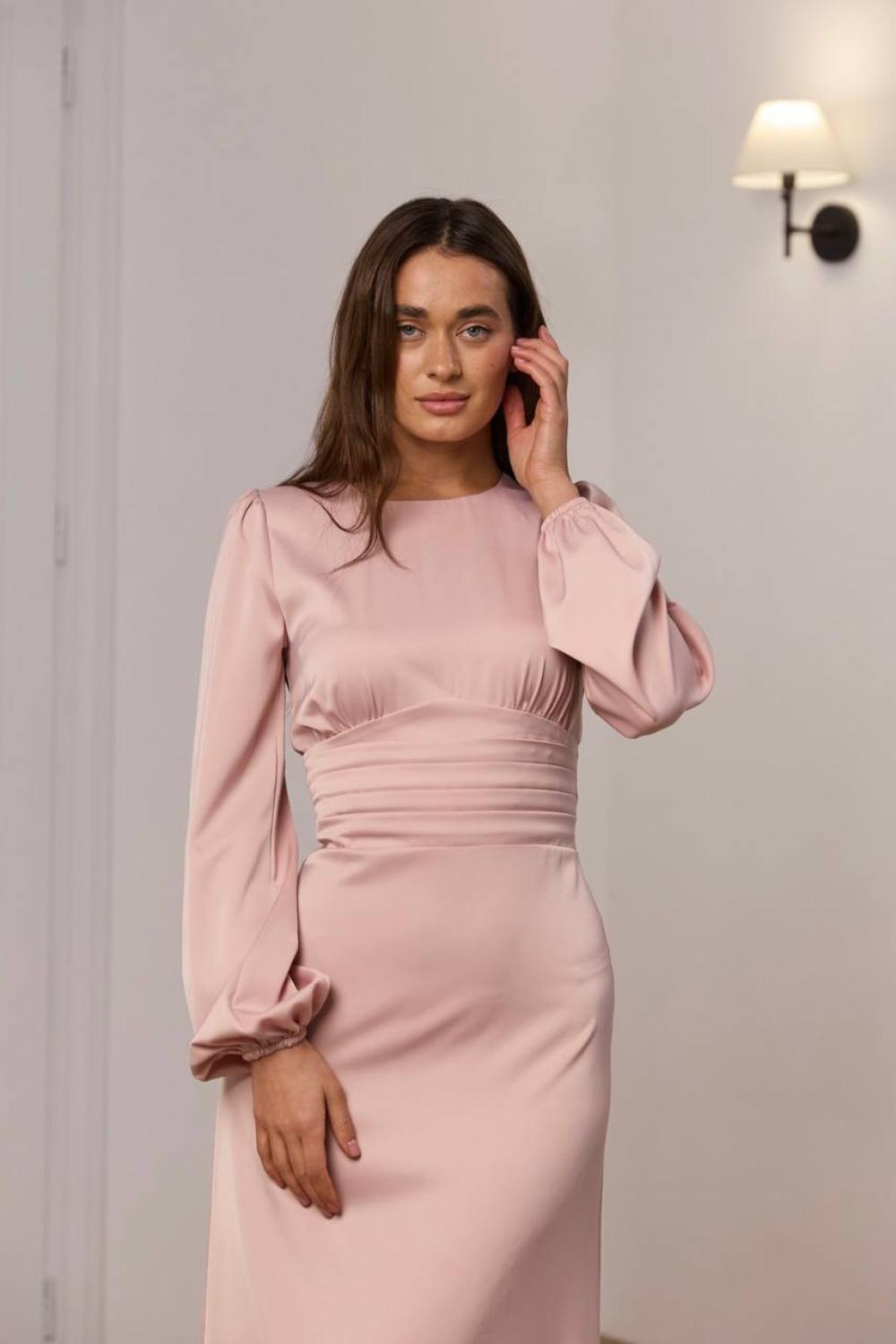 Elegant powder-colored midi-length dress.
