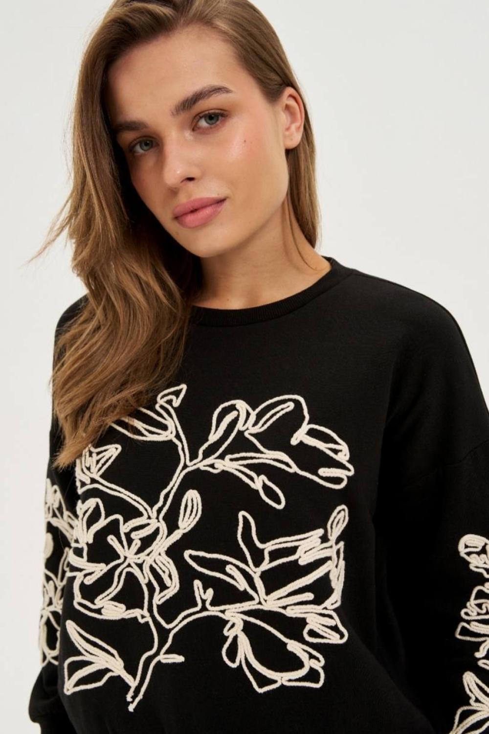 Black sweatshirt with floral appliqué